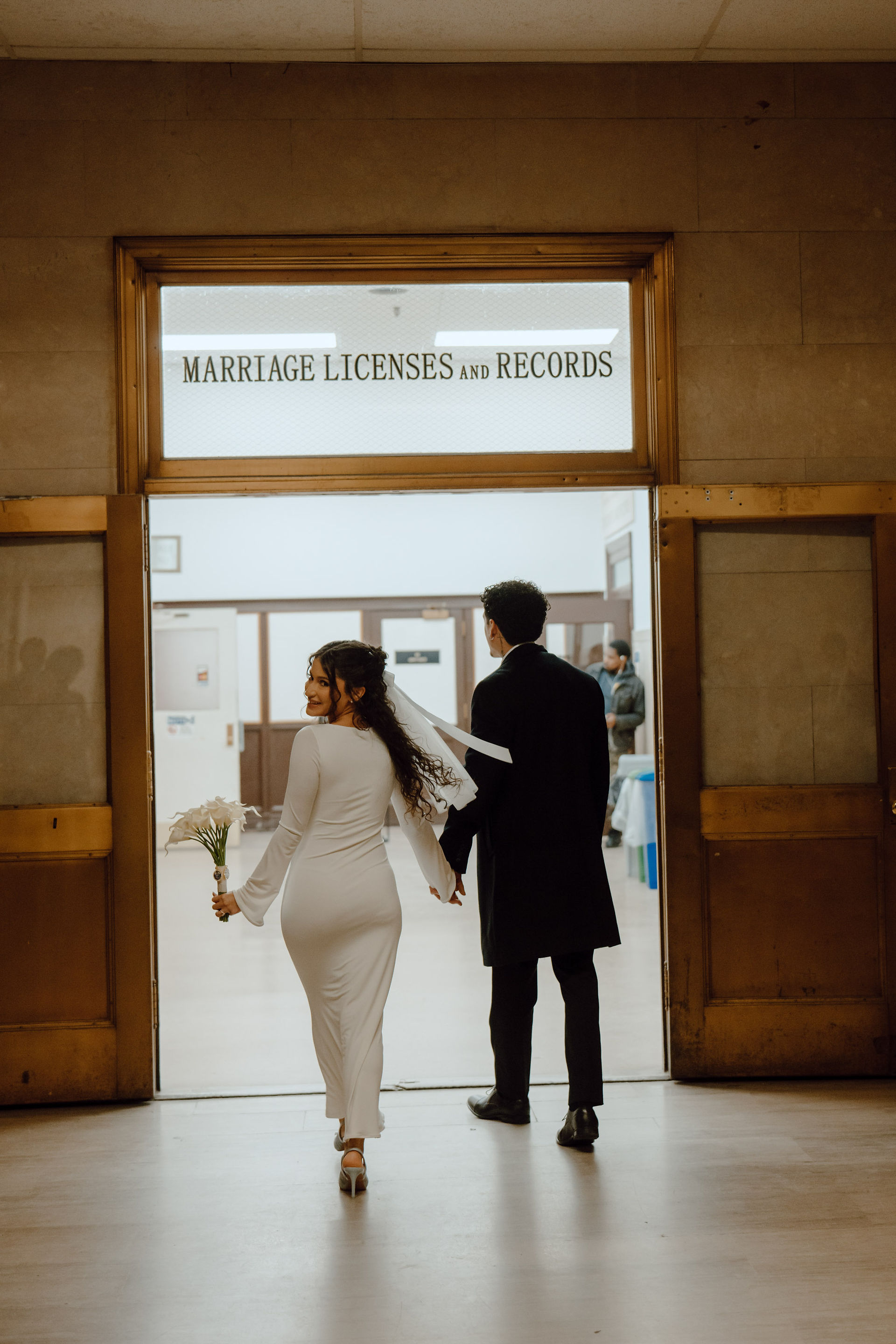 Couple walking out of Brooklyn City Hall Marriage Licenses and Records office after civil ceremony, Brooklyn City Hall elopement photography
