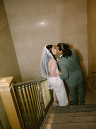 couple kissing on staircase brooklyn city hall wedding intimate documentary nyc