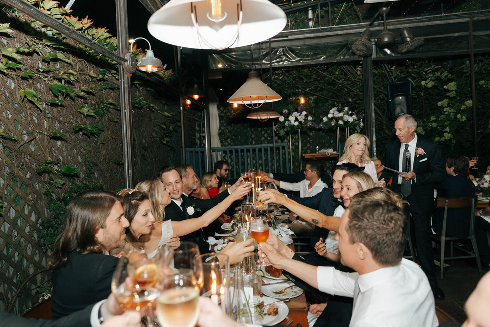 Guests raising a toast at a garden wedding reception in Williamsburg, Brooklyn