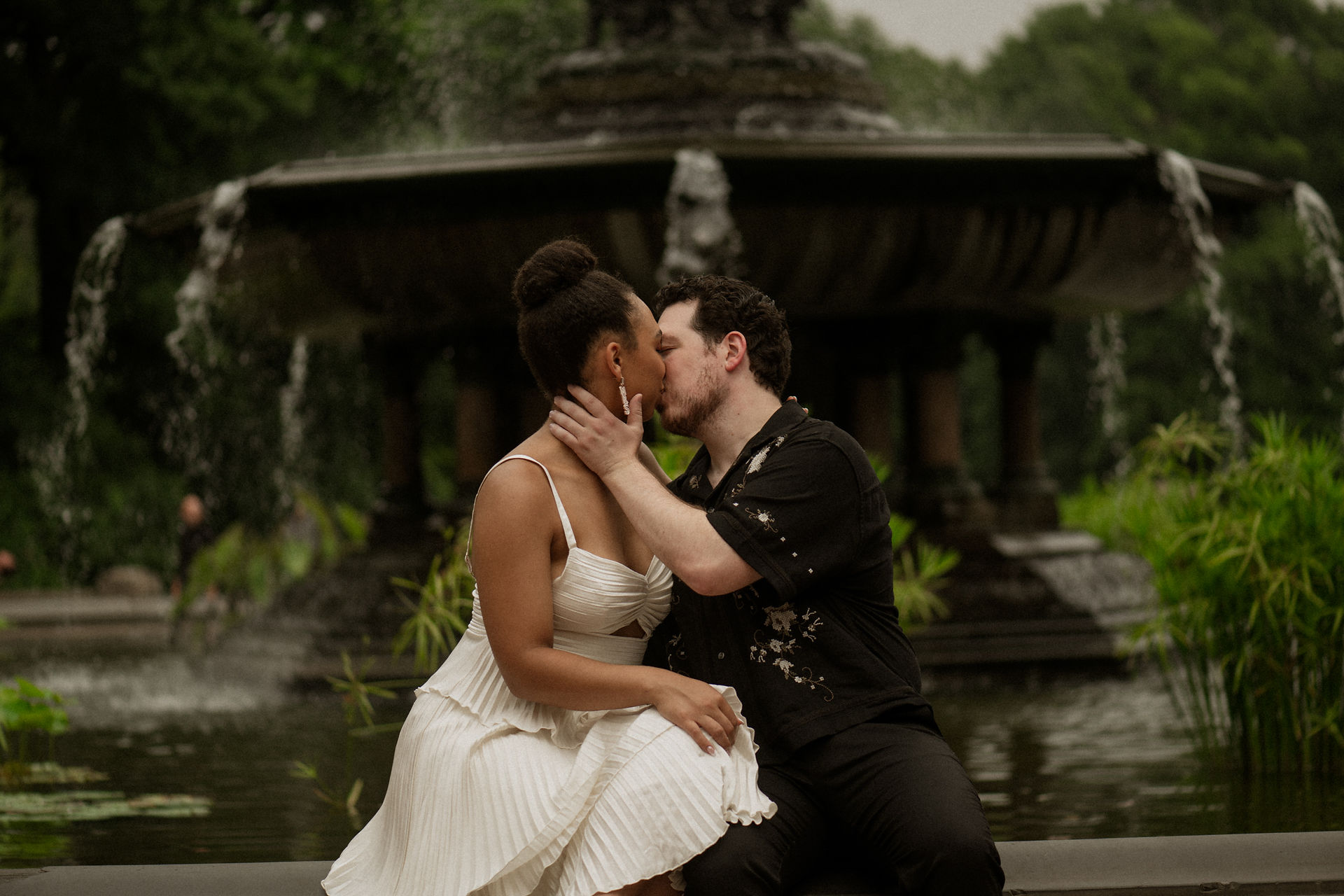 couple kissing bethesda fountain central park rainy day romantic engagement