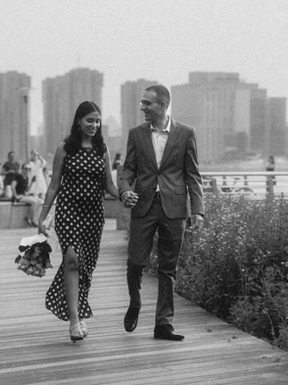 NYC proposal photographer capturing candid engagement photos along the East River waterfront in LIC