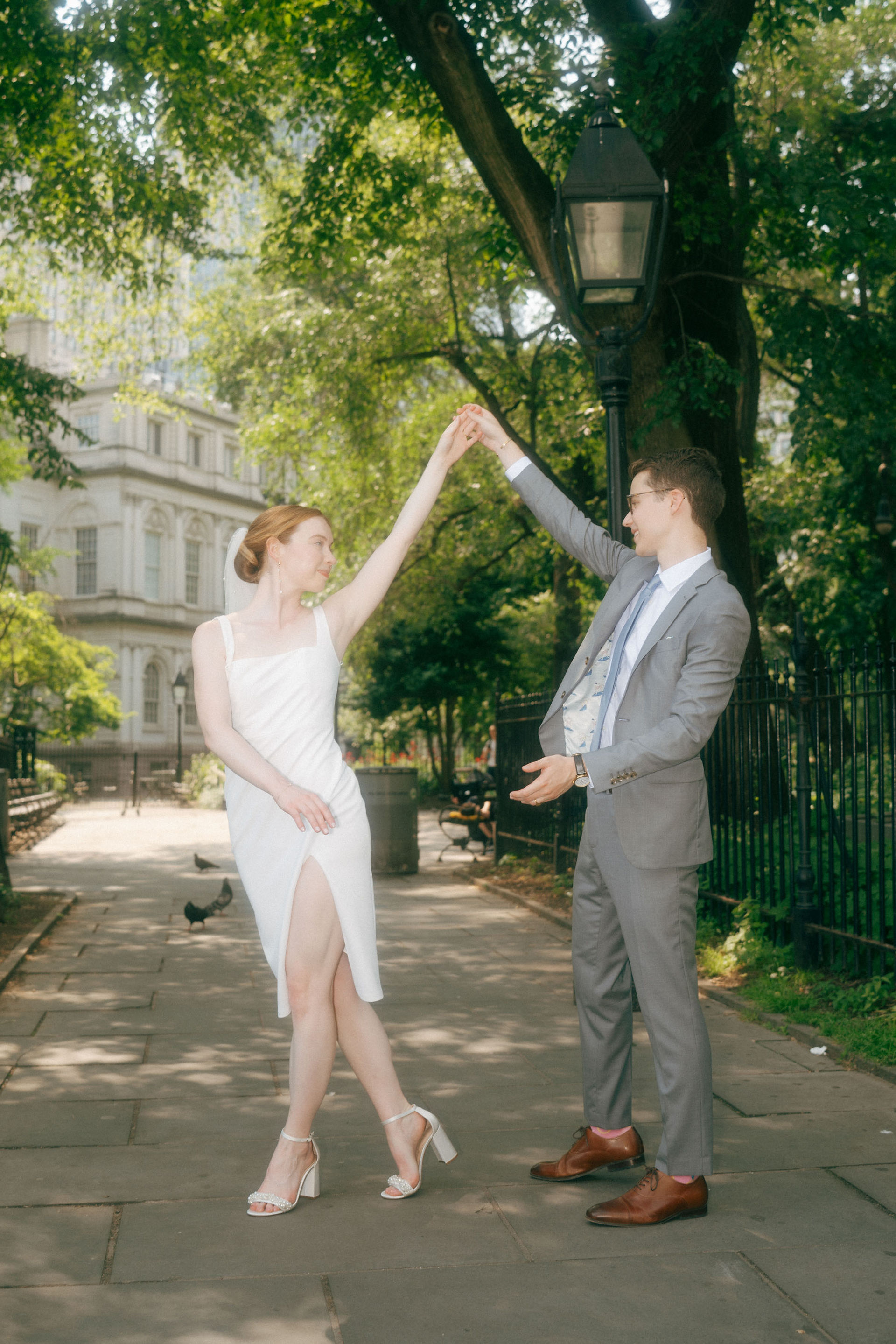 Couple dancing outside Manhattan City Hall after their NYC courthouse wedding ceremony.