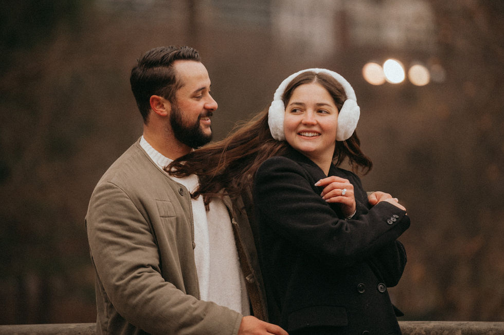 Central Park romantic couple photoshoot, woman smiling as man admires her