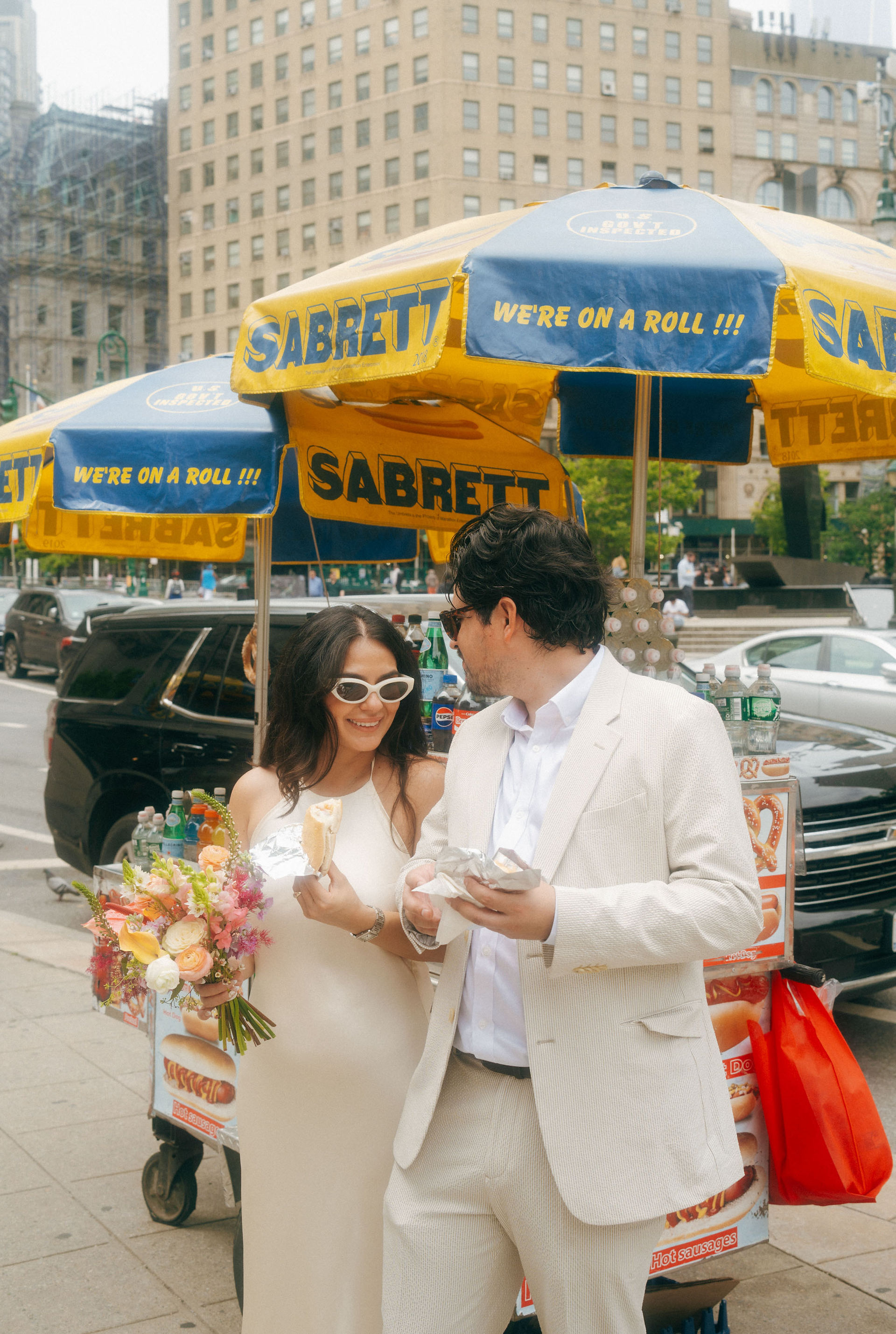 bride eating hot dog nyc street wedding day candid joyful