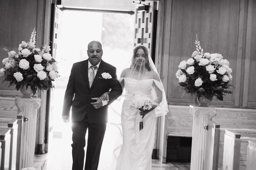 Candid documentary film photographer NYC capturing a bride's processional entrance at a Catholic wedding mass