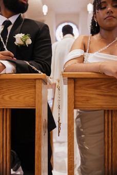 Cinematic candid photo of el lazo placed over bride and groom during a Spanish-language Catholic wedding mass