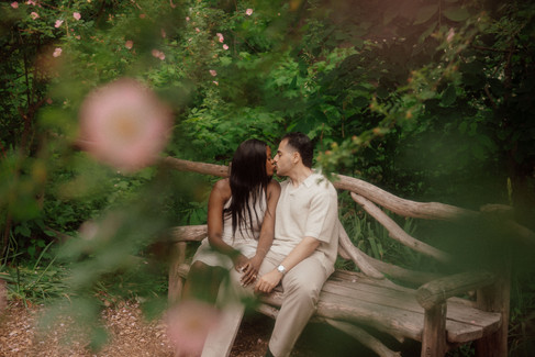 Proposal photography NYC, flower blossom engagement on a park bench