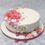 Thumbnail: Round cake covered in white sugar paste and decorated with pink and white roses and flowers on top