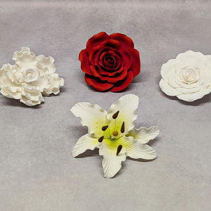 Red sugar rose, white sugar rose, white with yellow middle sugar stargazer lily and a white sugar peony. Wedding or Birthday cake decoration