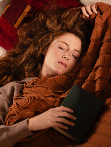 A woman sleeping in a blanket