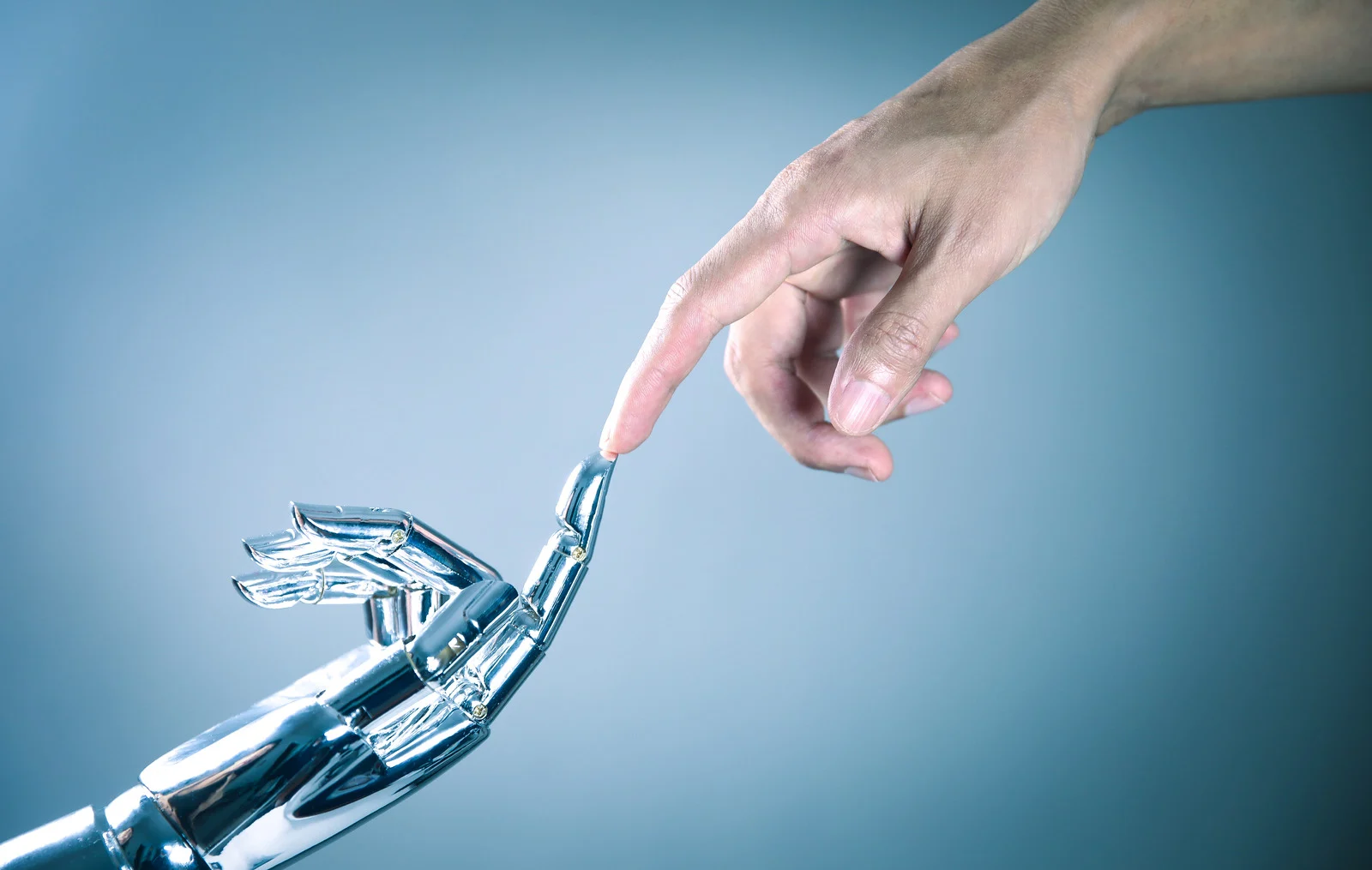 Human and robot hand connecting.webp