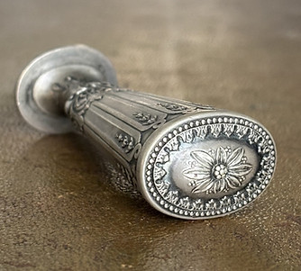 Details of a finely chiseled silver stamp for nobility.