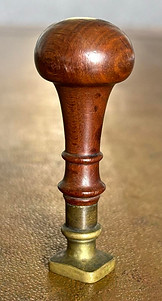 Antique wax seal stamp with a classic handle in precious wood.