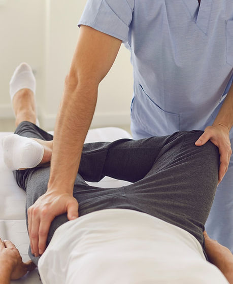 Therapist adjusting a patient's hip
