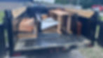 Utility trailer filled with wood and metal construction debris