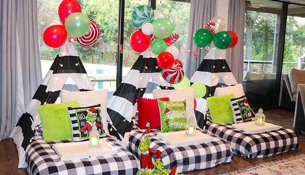Grinch-themed teepee sleepover with green and red decor, Christmas lights, and festive Whoville touches