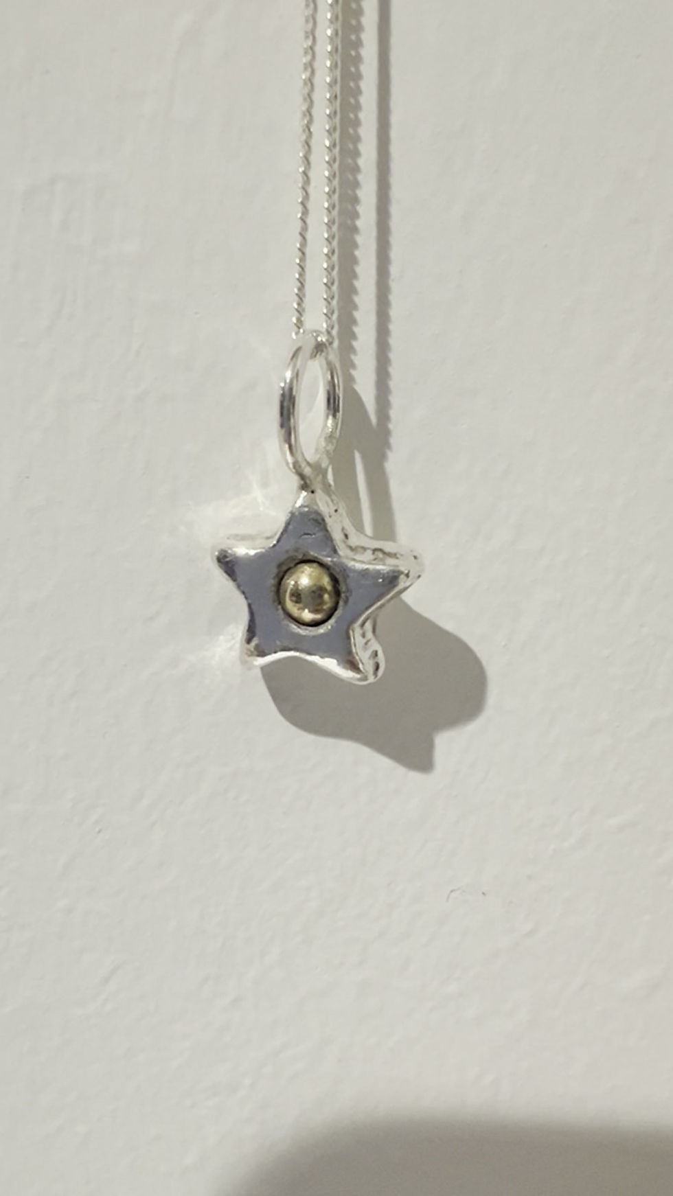 A beautiful fine silver star with a 9ct gold centre for someone speciall.