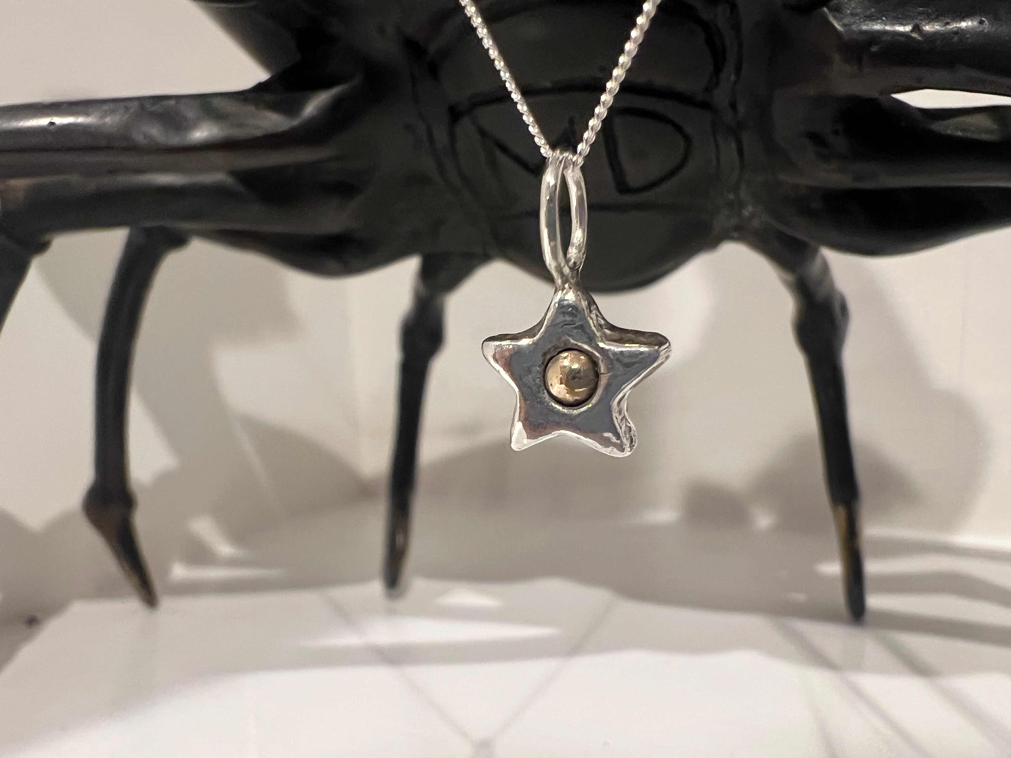 Chunky fine silver Christmas star with solid gold centre
