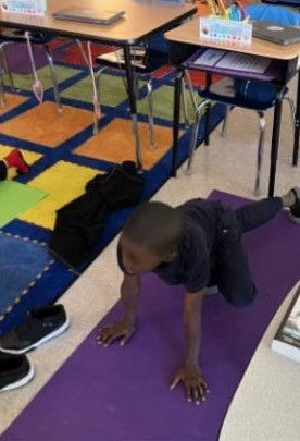 a student practicing yoga on a yoga mat