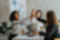 stock image of 3 women at work high-fiving