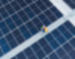A staff checking solar panels