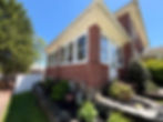 Red brick home featuring fresh exterior painting on trim.