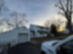 Professional exterior painting of a white two-story house