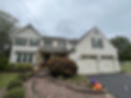 Professional exterior painting on a two-story house.