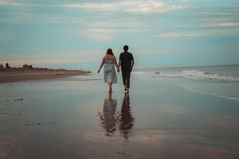 Couple holding hands at Rehoboth Beach, DE