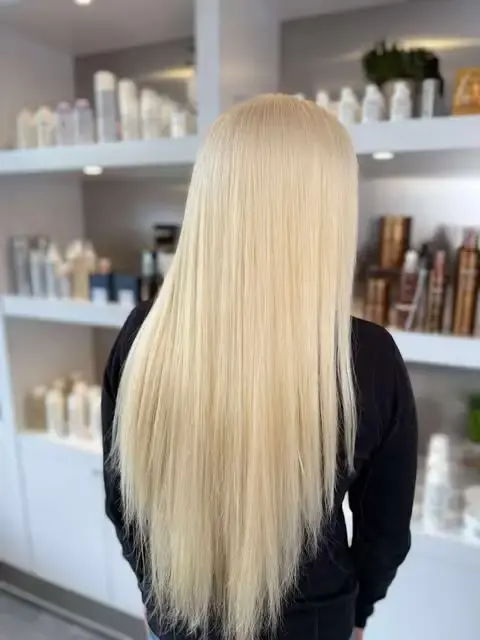 Back view of long straight platinum blonde hair.