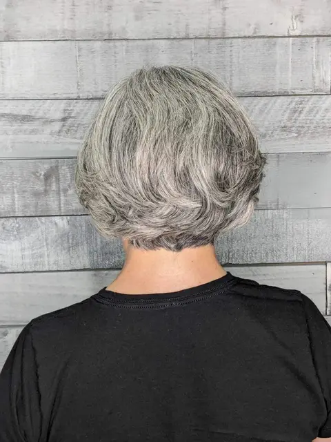Close-up view of a gray bob hairstyle with soft layers, showcasing a sleek and elegant finish.