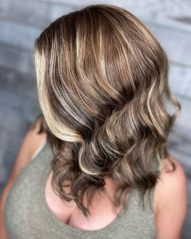 Long layered hair with natural lowlights for added depth and texture.