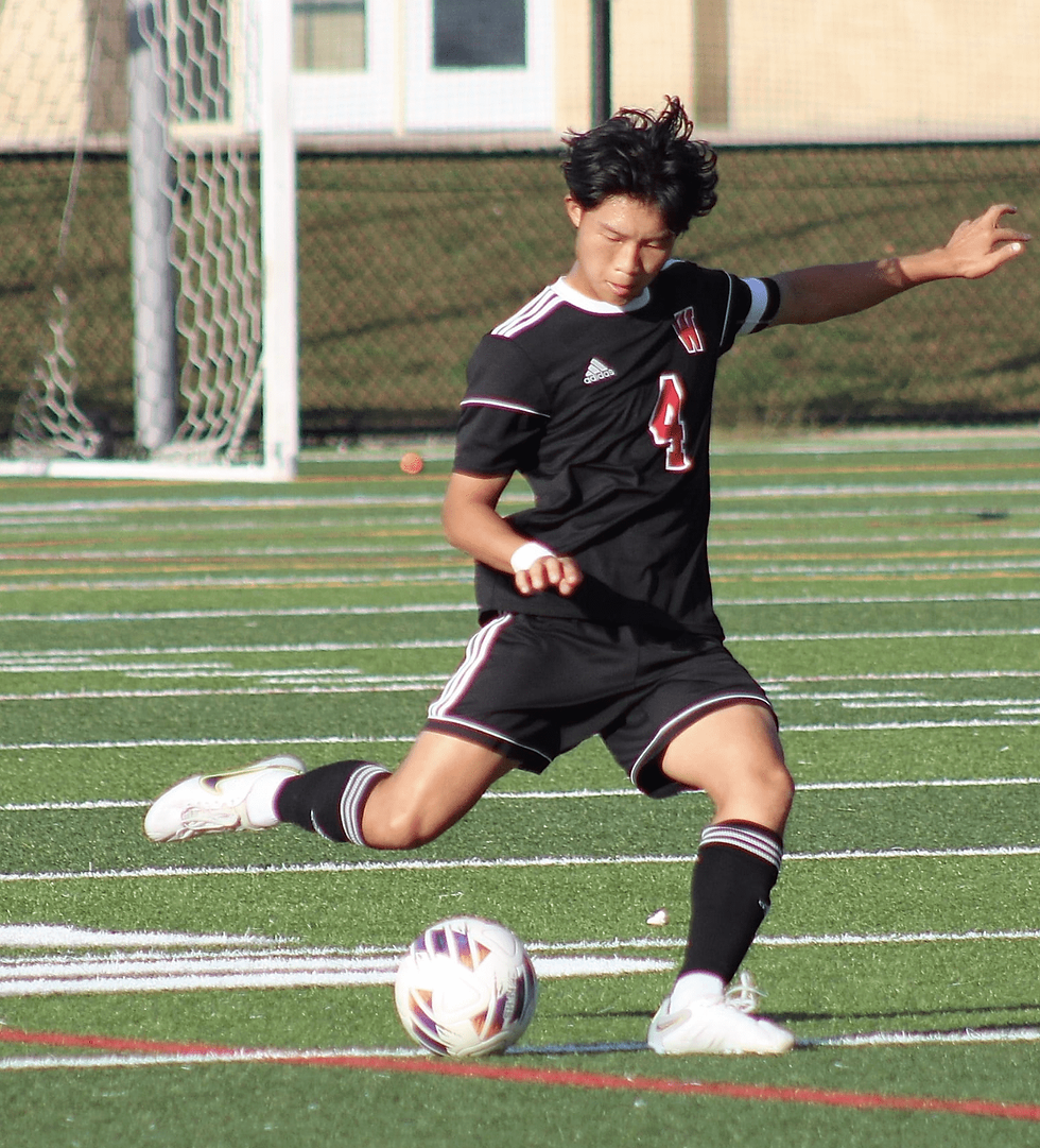 Winchester High School boys soccer senior tri-captain Marvin Li (4) boots the ball into the offensive zone to set up a play during the Wakefield game on Sept. 30. COURTESY PHOTO/WINCHESTER HIGH SCHOOL BOYS SOCCER