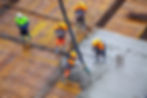 Construction site with men working with cement