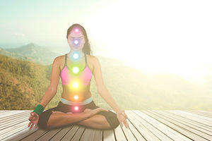 Picture of Indian woman doing meditation with colored chakra points on her body. Shot at n