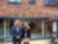 Man and women  in front of housing development