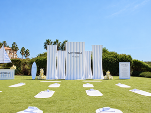 Blue-and-white SAINT BELLA event backdrop, sailboat installation and yoga mats at Waldorf Astoria Monarch Beach in Dana Point, designed by IDO Events.