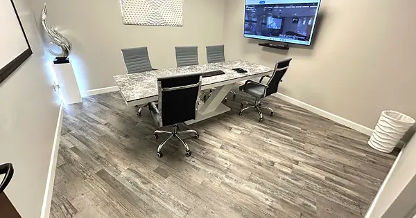 Executive Room at West Valley Coworking in Glendale, AZ featuring a professional meeting table, TV, whiteboard and comfortabl