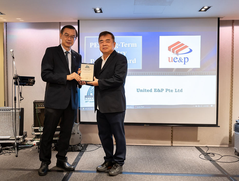 Mr. Elvin Koh (right) receiving the PES Long-Term Industry Partner Award for United E&P Pte Ltd