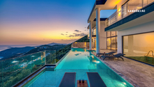 Autonomous drone conducting aerial security surveillance over a luxury estate at night, monitoring the perimeter and private grounds