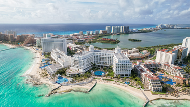 Hotel or resort property with buildings, amenities, and surrounding grounds