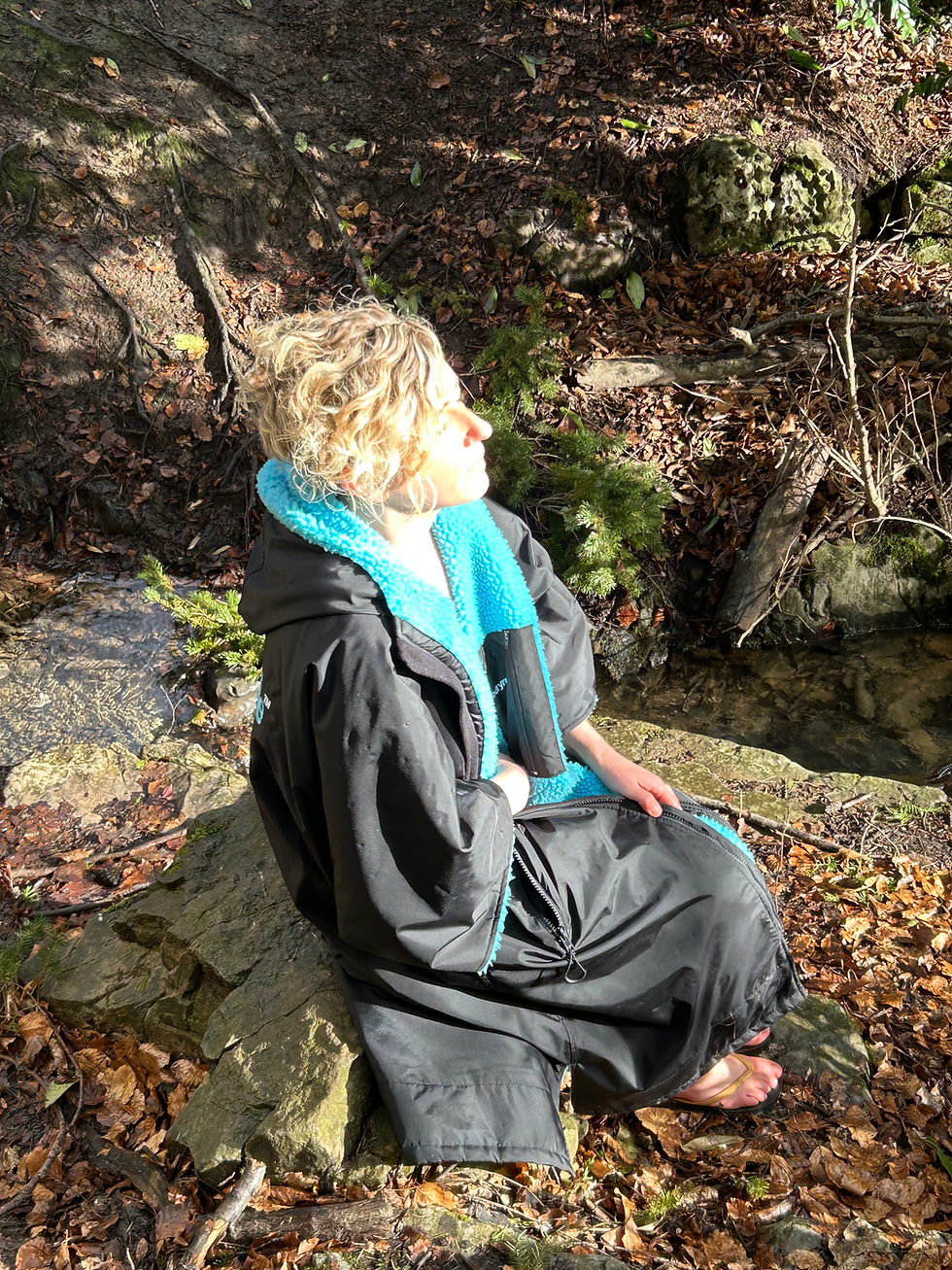 L holding a gemstone over her womb after her waterfall dip