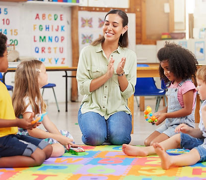 shot-of-a-teacher-singing-with-her-preschool-children