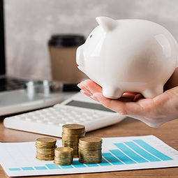 hand-holding-piggy-bank-with-growth-chart-coins.jpg