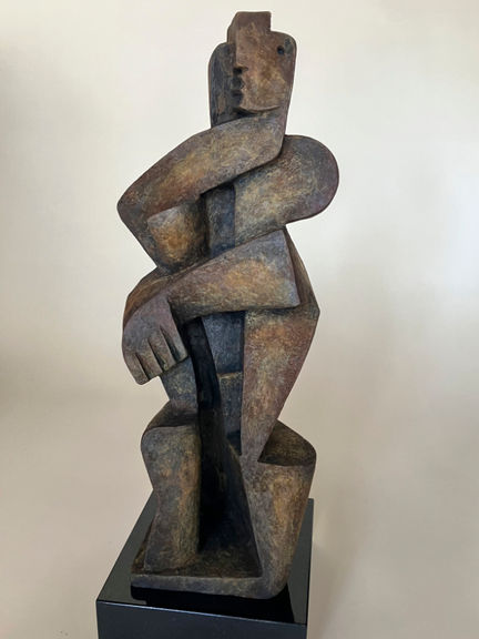 An abstract, cubist sculpture of a man standing.