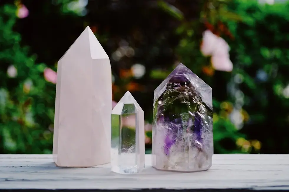 Three large crystal points sitting on a picnic table.