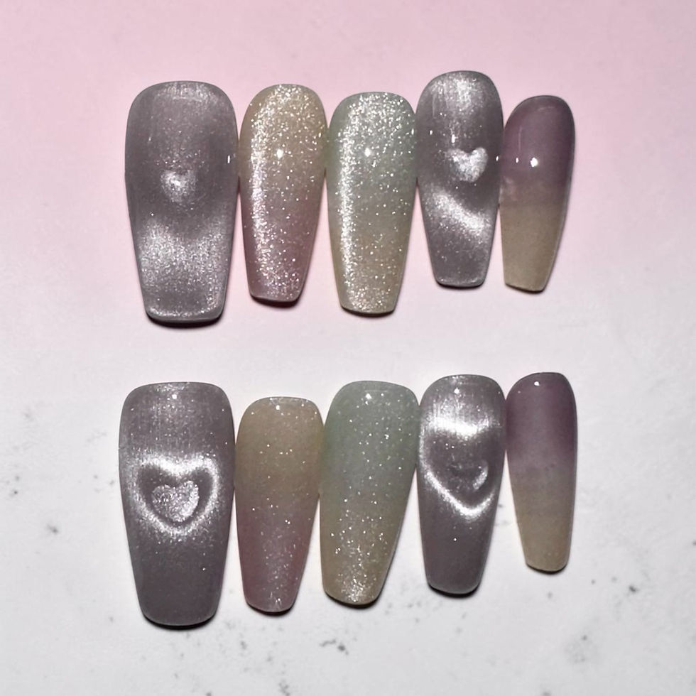 Cloud Nine press-on nails by M Press Beauty featuring dreamy lavender, champagne, blush pink, and soft sage shimmer with ombré finishes and glowing heart accents in a long coffin shape.