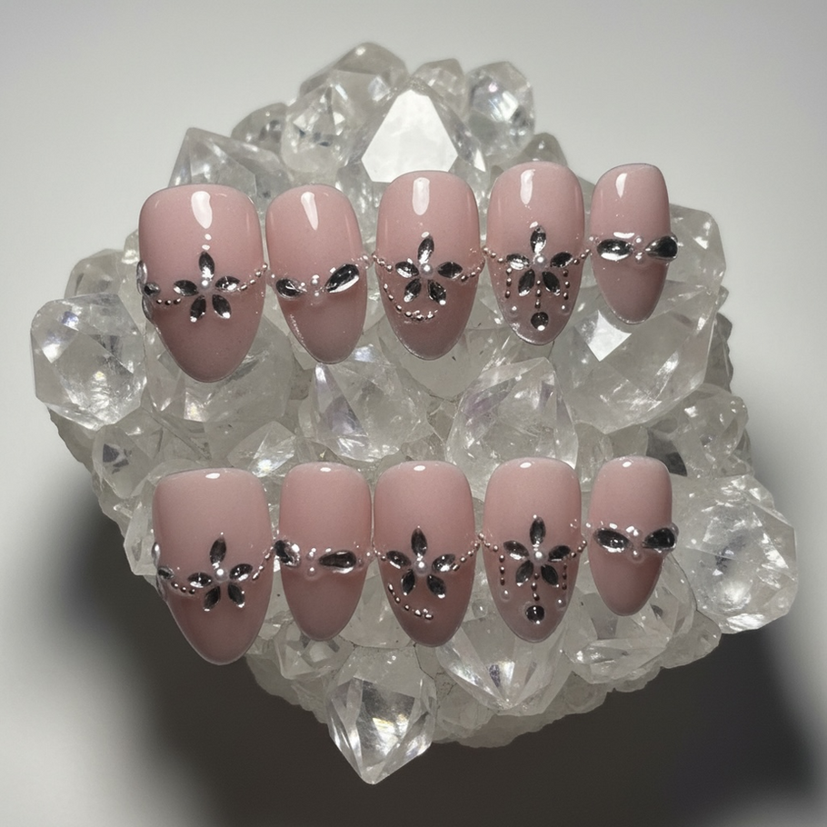 Blush Dynasty press-on nails featuring a glossy dusty-mauve base with elegant black crystal floral designs, teardrop-shaped rhinestones, and delicate silver beaded accents in a tapered square shape.