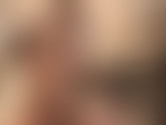 Me, Theresa with large headphones on smiling behind a mic