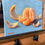 Thumbnail: A still life oil painting of a glowing peeled orange in segments.